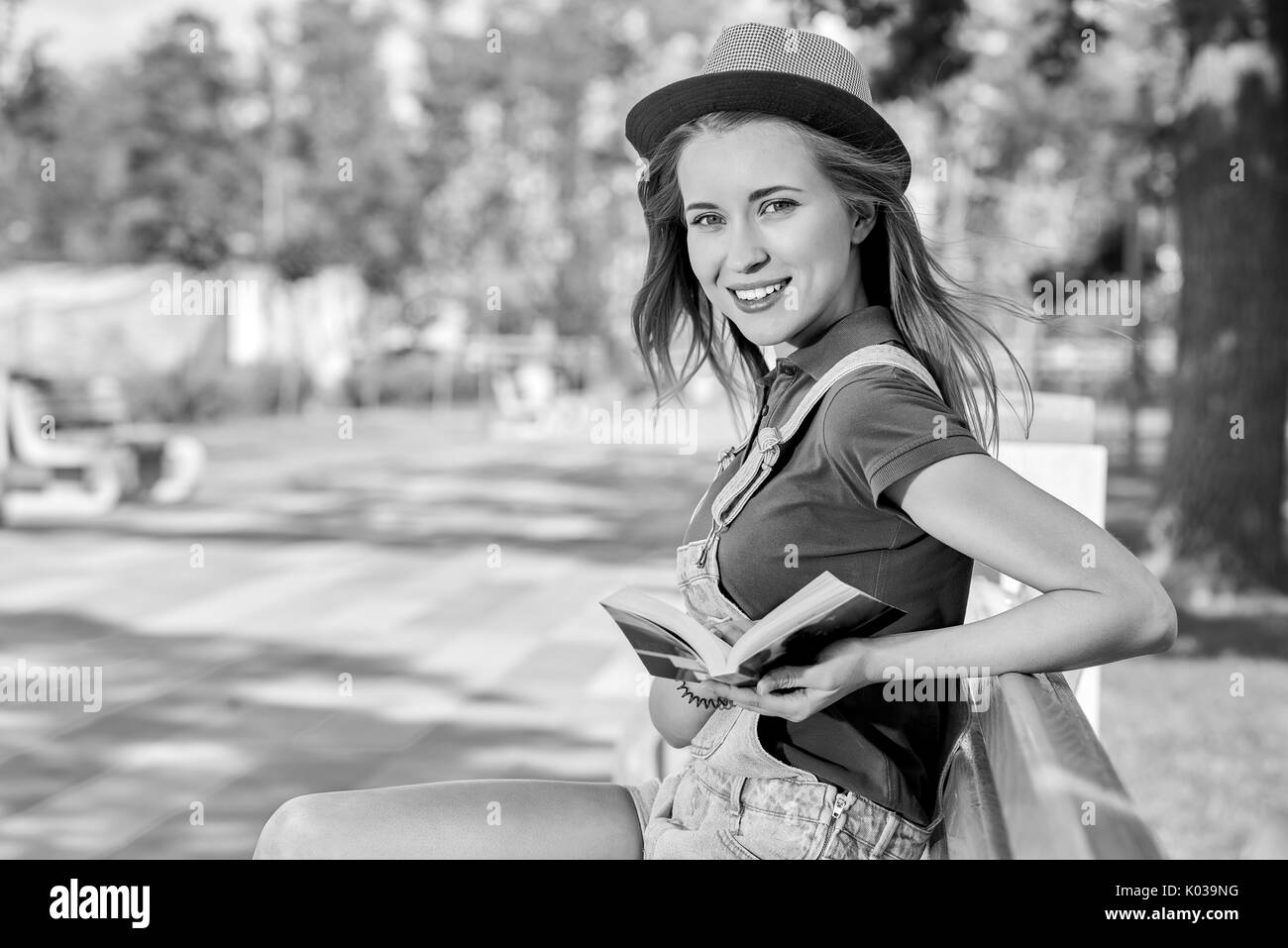 Young beautiful woman reading book at the park Stock Photo