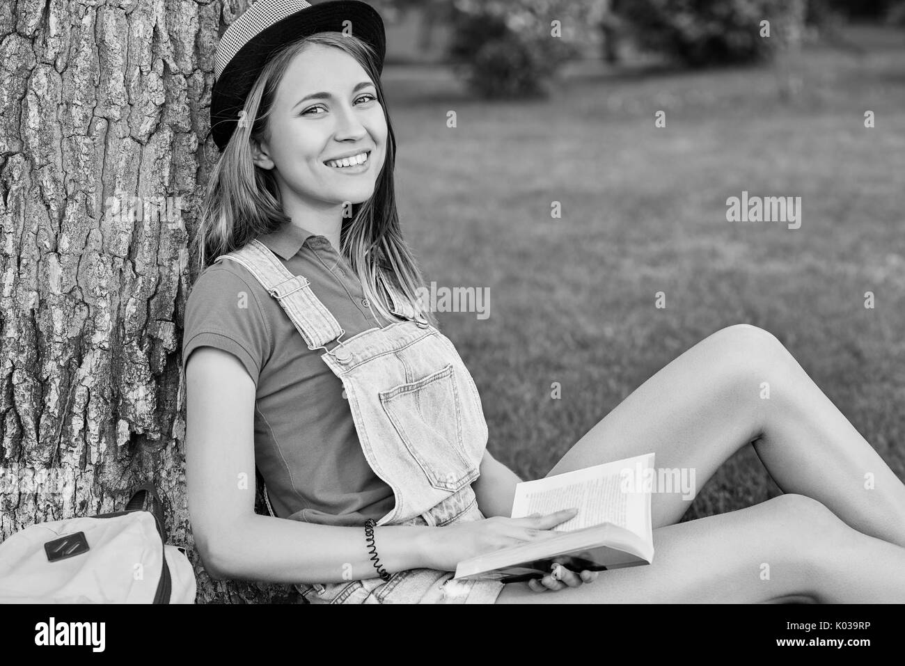 Young beautiful woman reading book at the park Stock Photo
