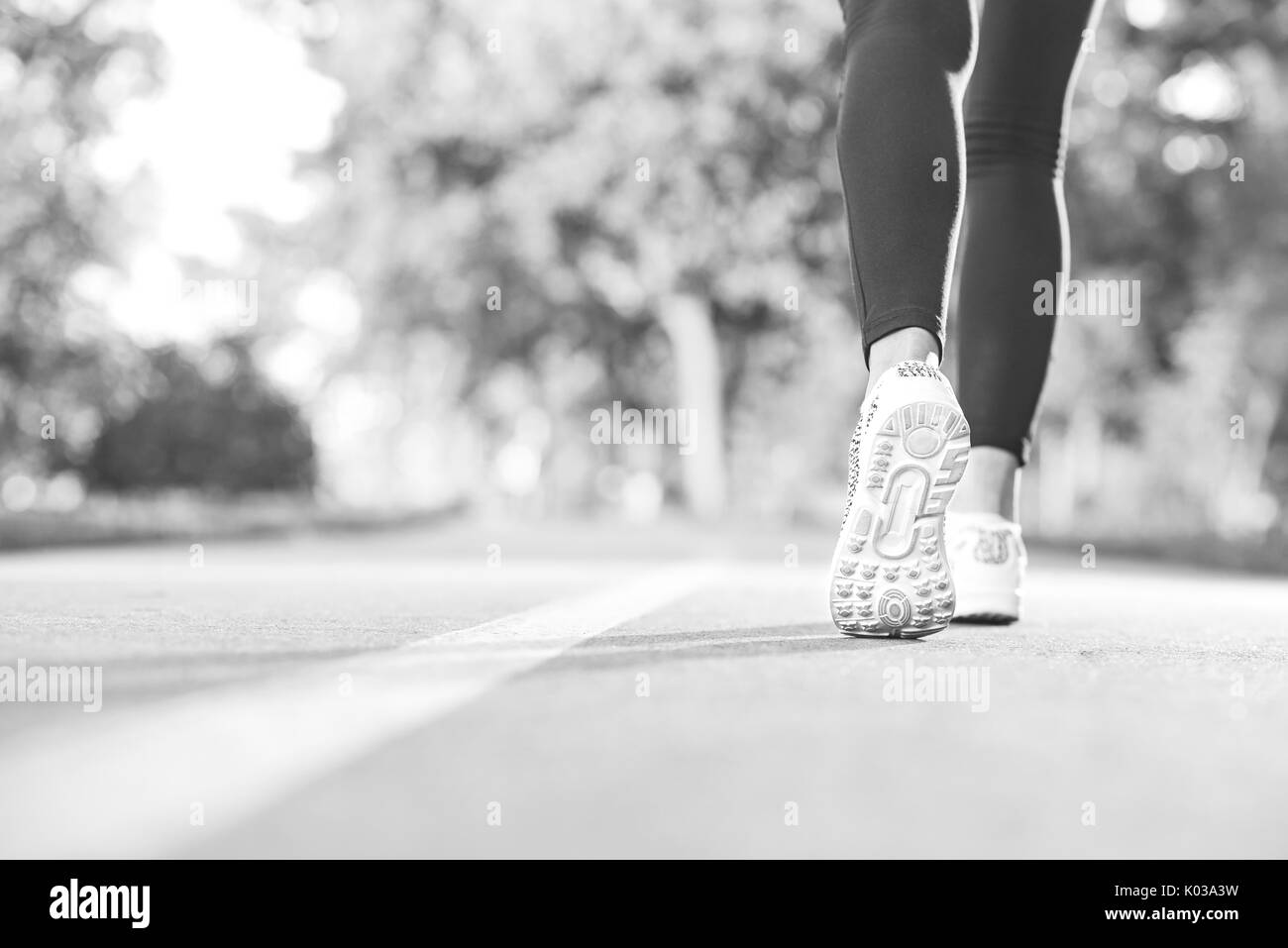 Female runner jogging in the forest Stock Photo