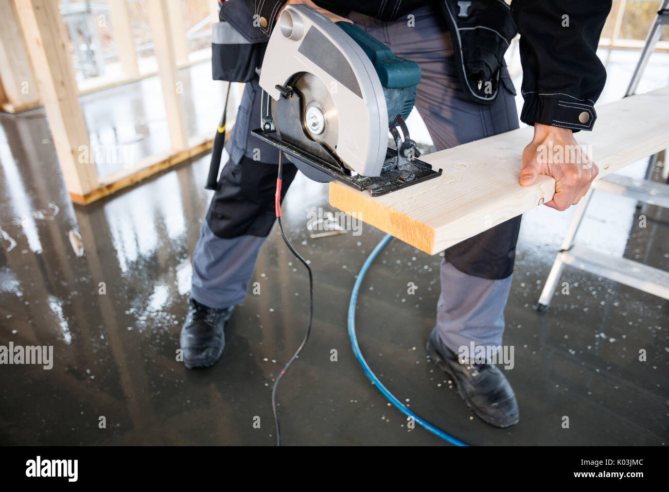 Low Section Of Carpenter Using Electric Saw To Cut Wood Stock Photo Alamy