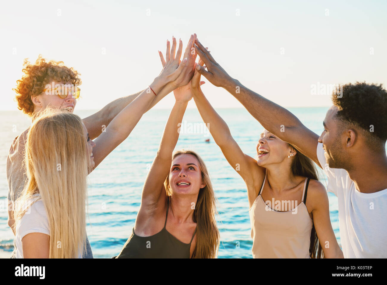 Group of friends having fun on the beach Stock Photo
