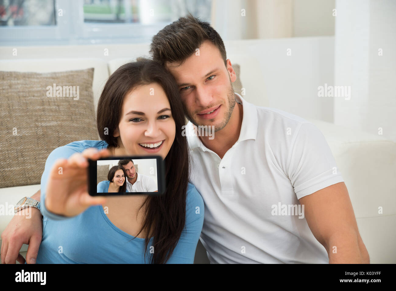Portrait Of Young Couple Taking A Selfie With Mobile Phone Stock Photo ...
