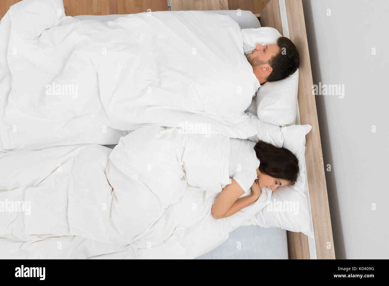 High Angle View Of Young Couple Sleeping On Bed Stock Photo - Alamy