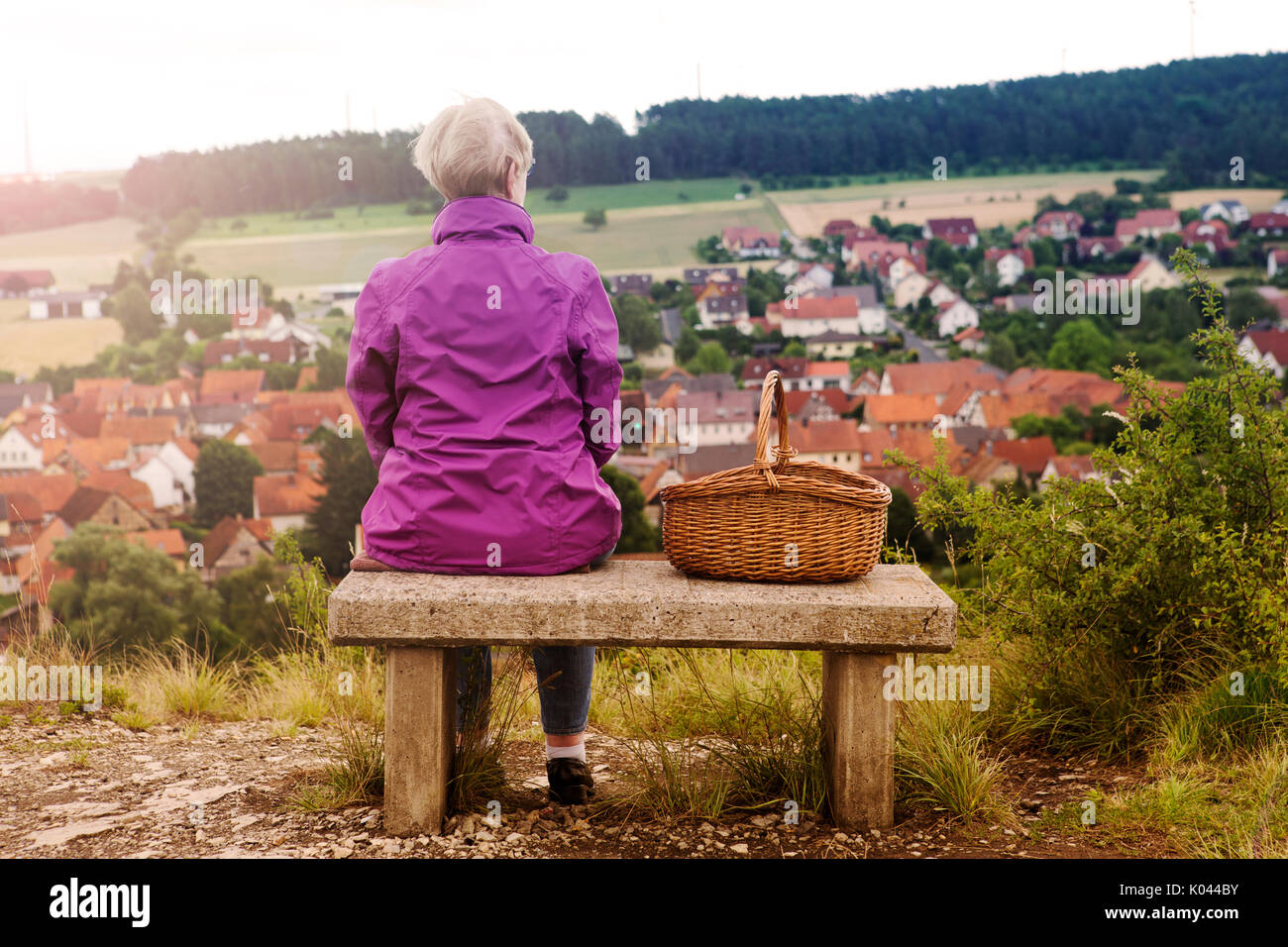 Mature woman thinking sitting bench hi-res stock photography and images ...