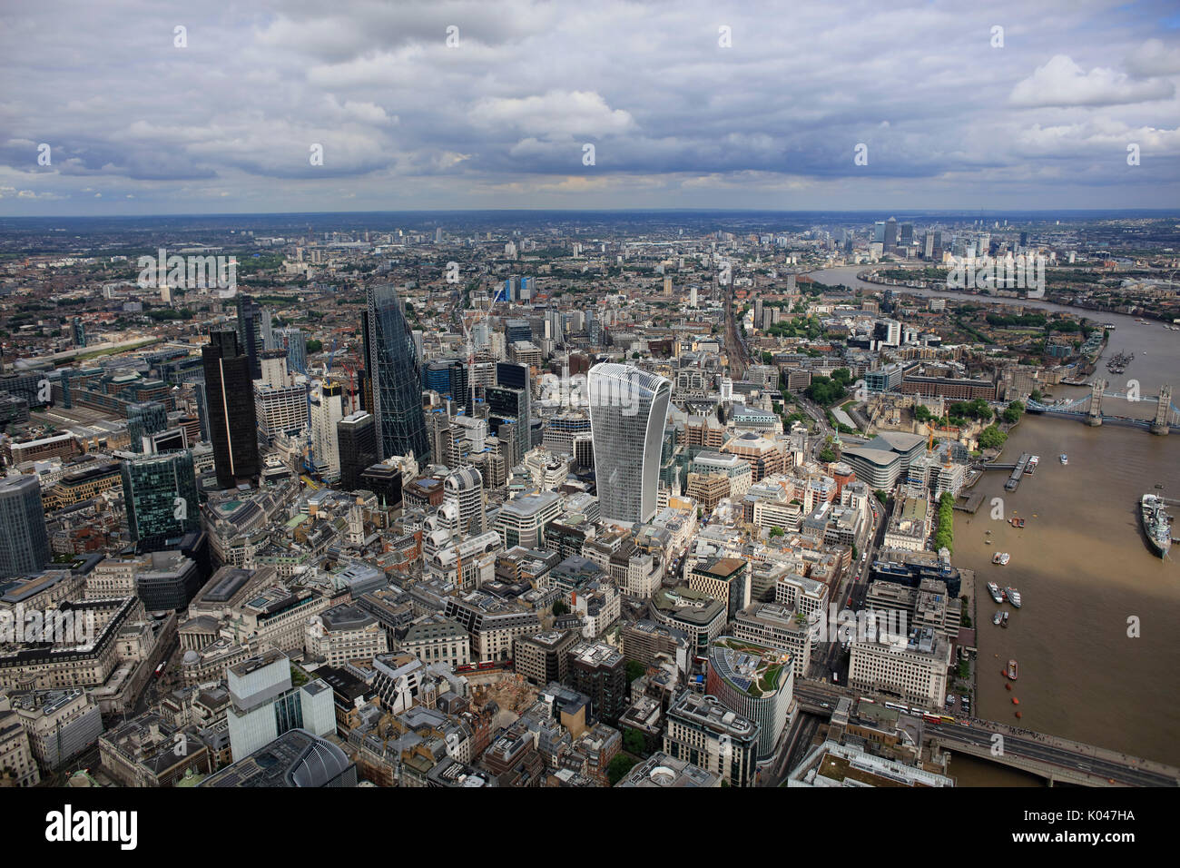 An aerial view of the skyscrapers of the City of London with the River Thames and Tower Bridge visible Stock Photo