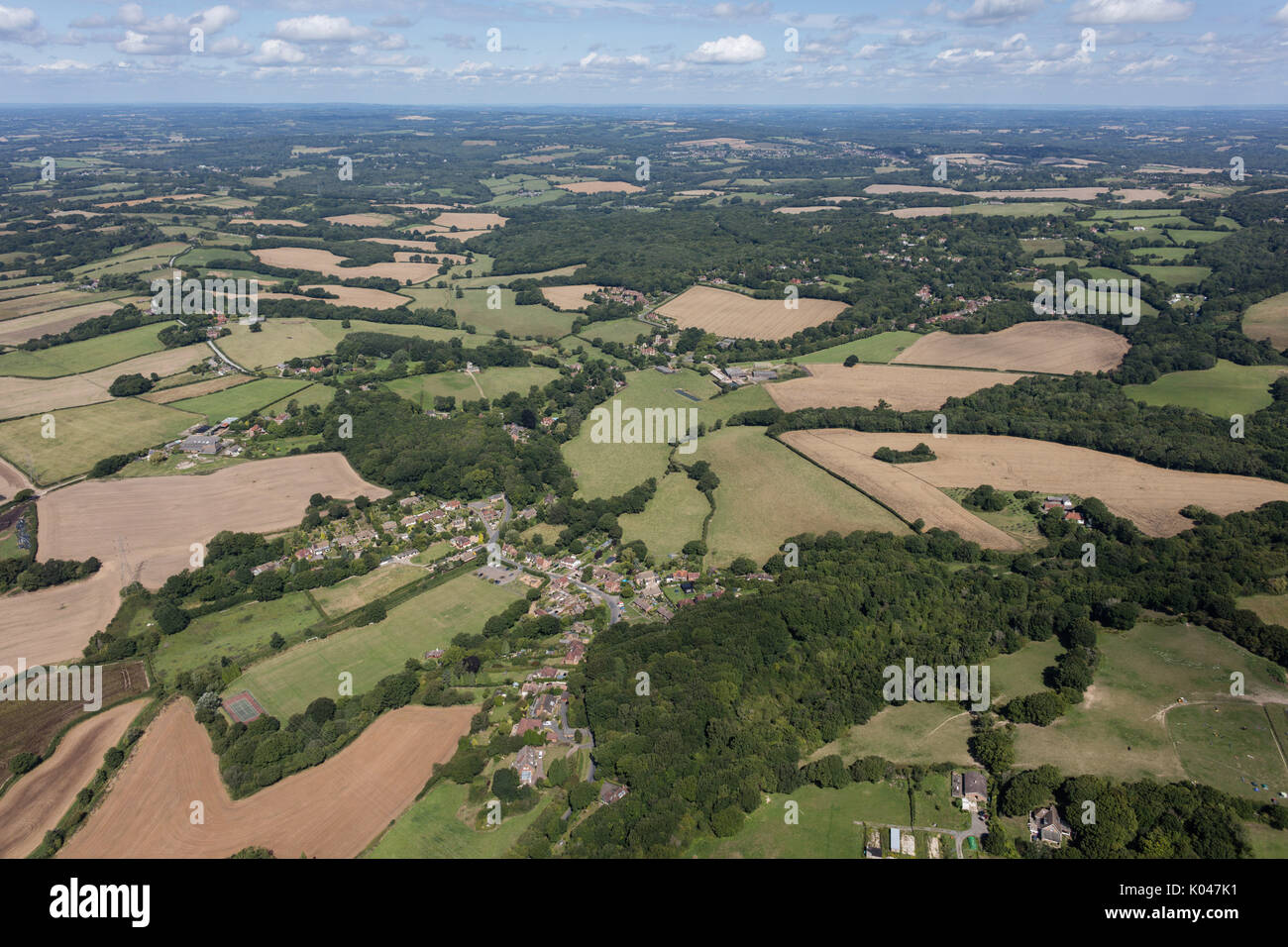 An aerial view of East Sussex on a fine summer day with the village of