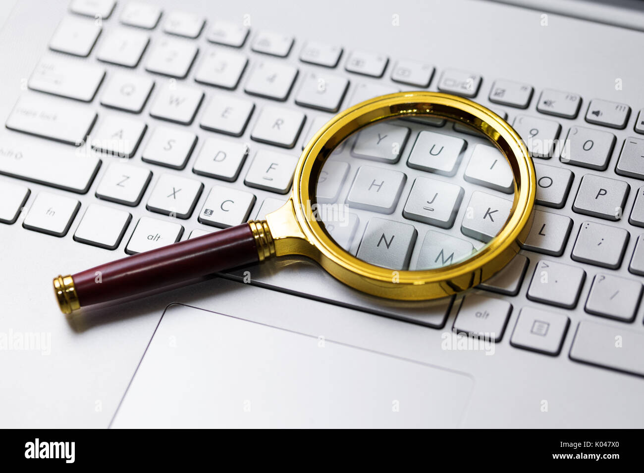 information search on internet concept. magnifying glass on the keyboard Stock Photo