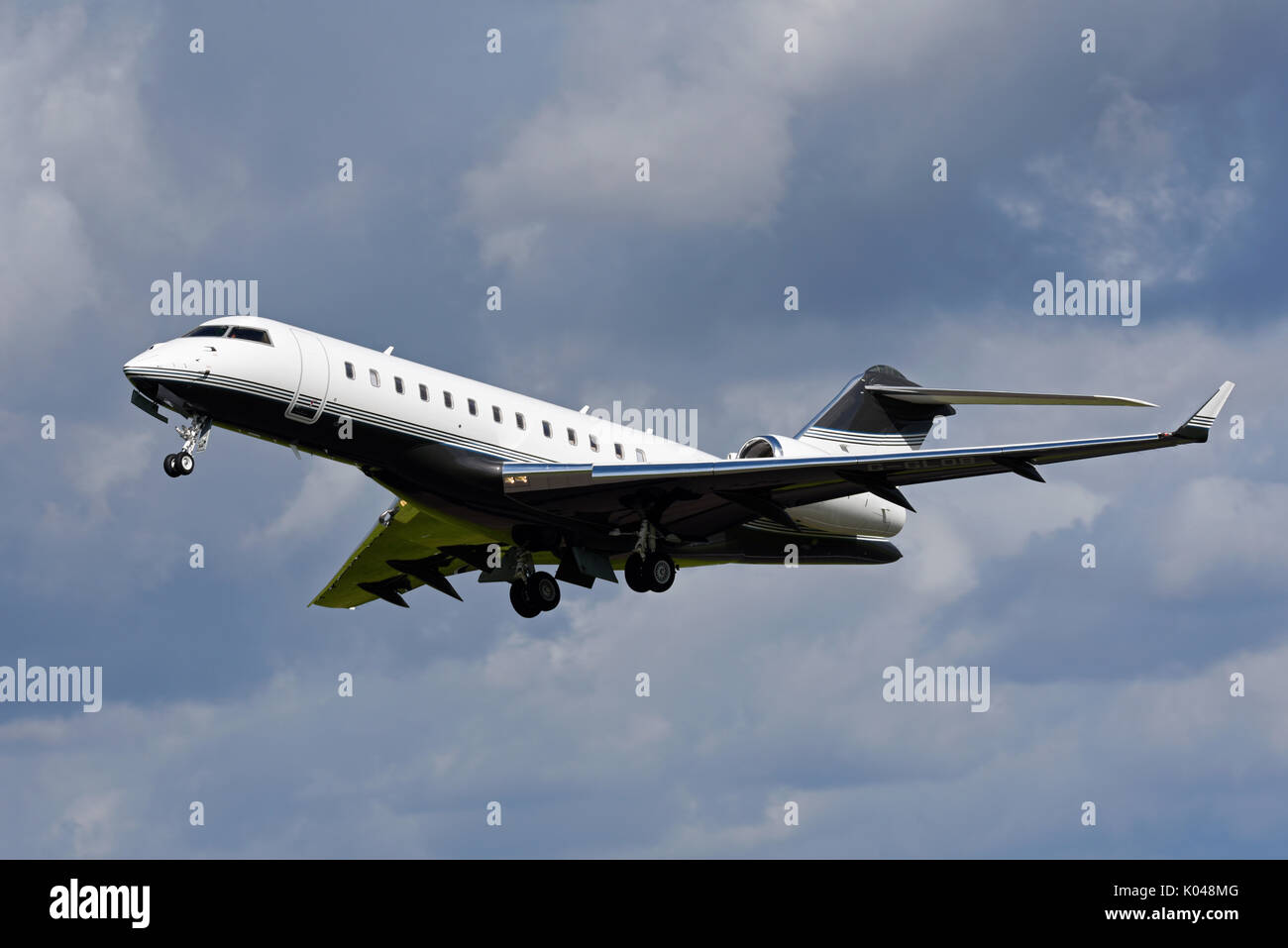 Bombardier Global Express BD 700 executive jet G-GLOB owned by Execujet of Cambridge taking off at Biggin Hill Airport, Kent, UK. Space for copy Stock Photo