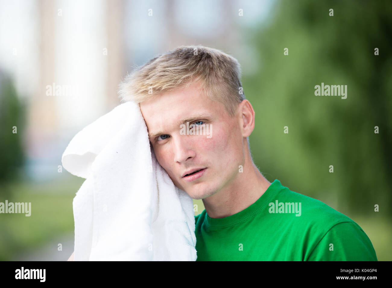 Tired man after fitness time and exercising. With white towel Stock Photo