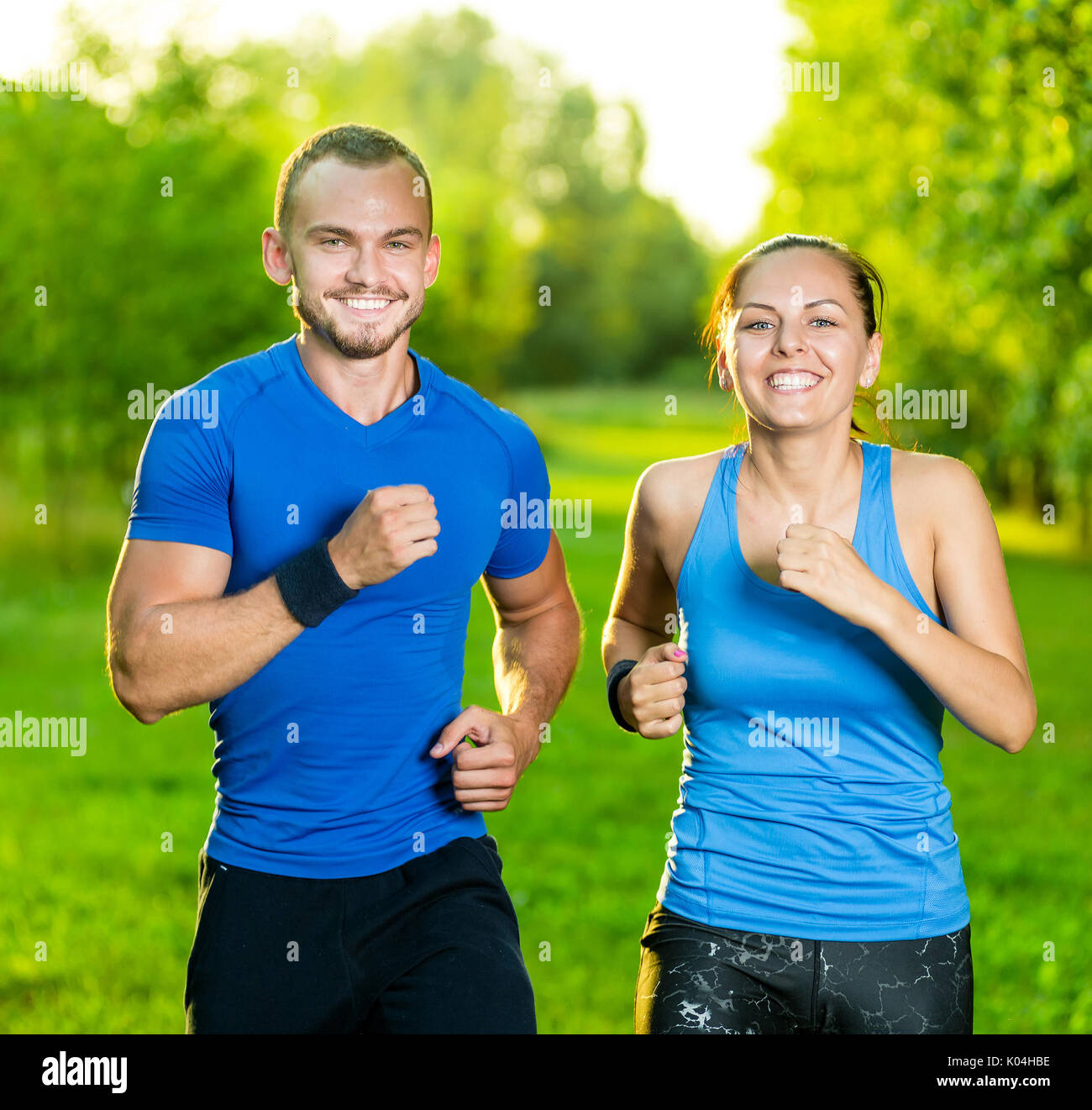 Runners training outdoors working out. City running couple jogging outside.  Stock Photo