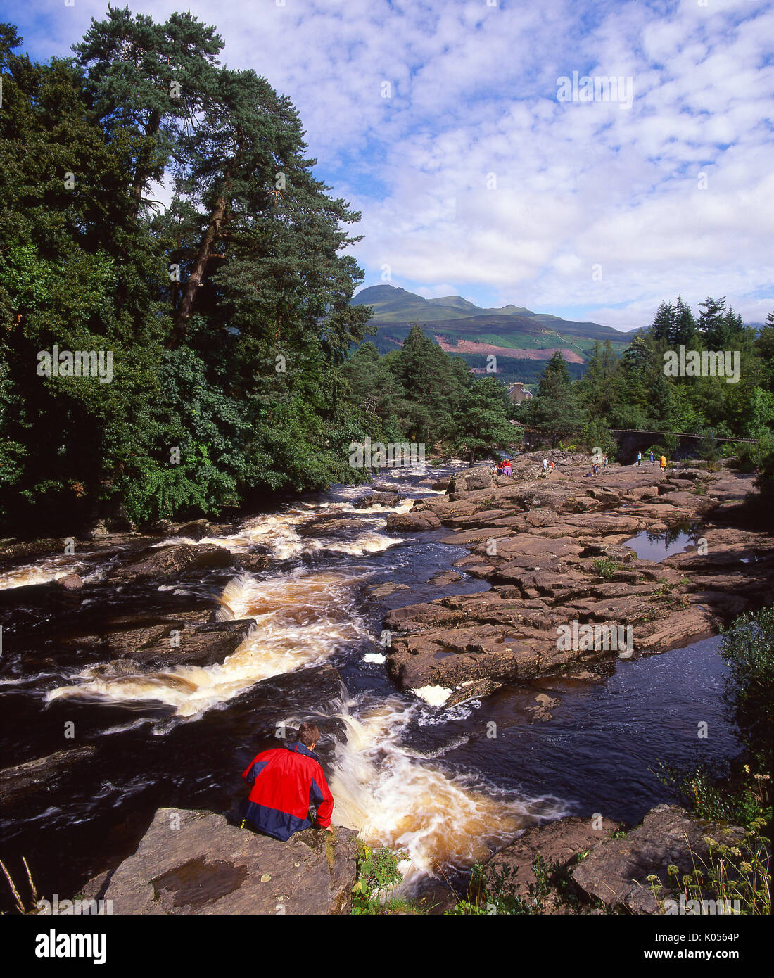 A beautiful summer view of the fast flowing Falls of Dochart situated in the picturesque village of Killin, Perthshire Stock Photo