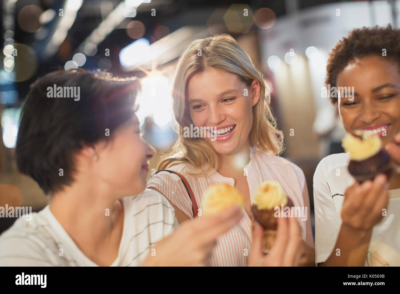 Young women eating cupcakes Stock Photo