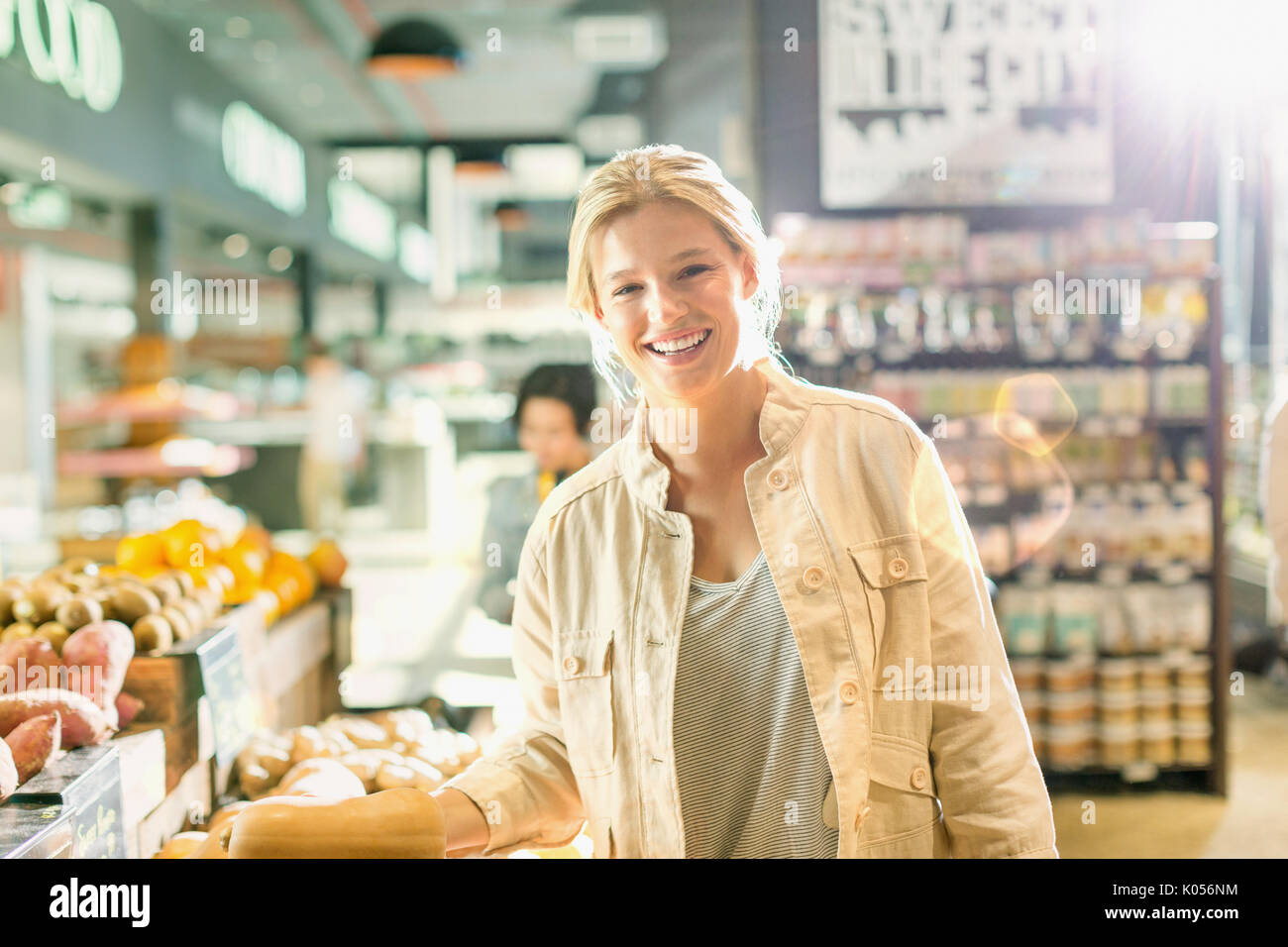 Portrait smiling young woman grocery shopping in market Stock Photo