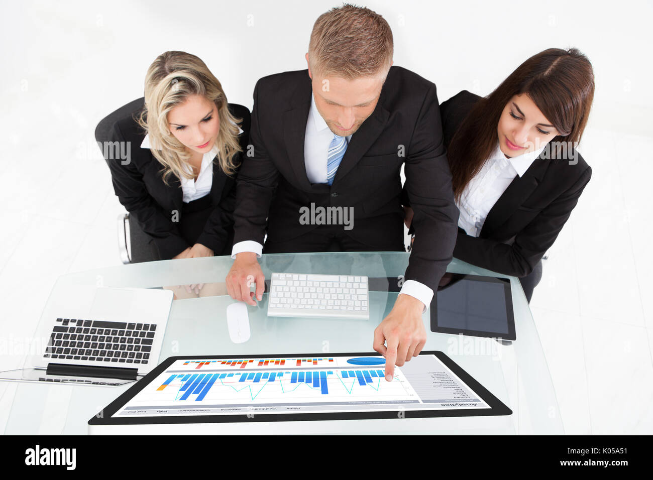 High angle view of businesspeople using desktop PC together at desk in ...