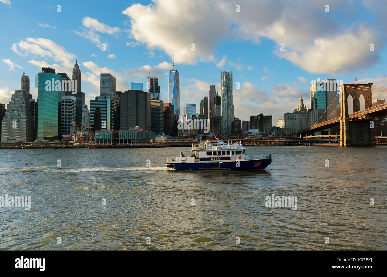 New York City, USA - August 16, 2017: American police boat N.Y.P.D patrolling under the Brooklyn Bridge in Manhattan New York City, USA. Stock Photo