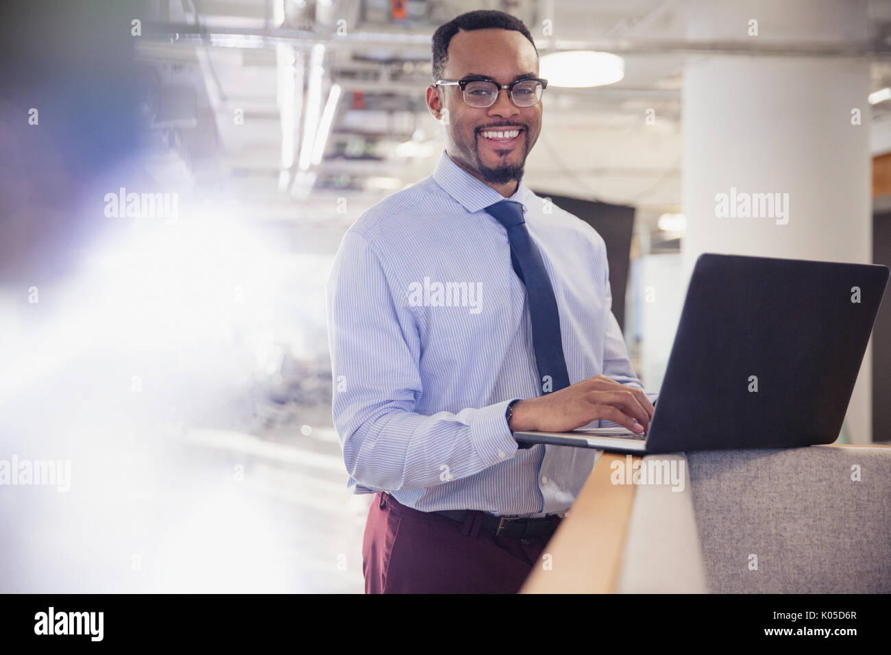 Portrait smiling businessman using laptop in office Stock Photo - Alamy