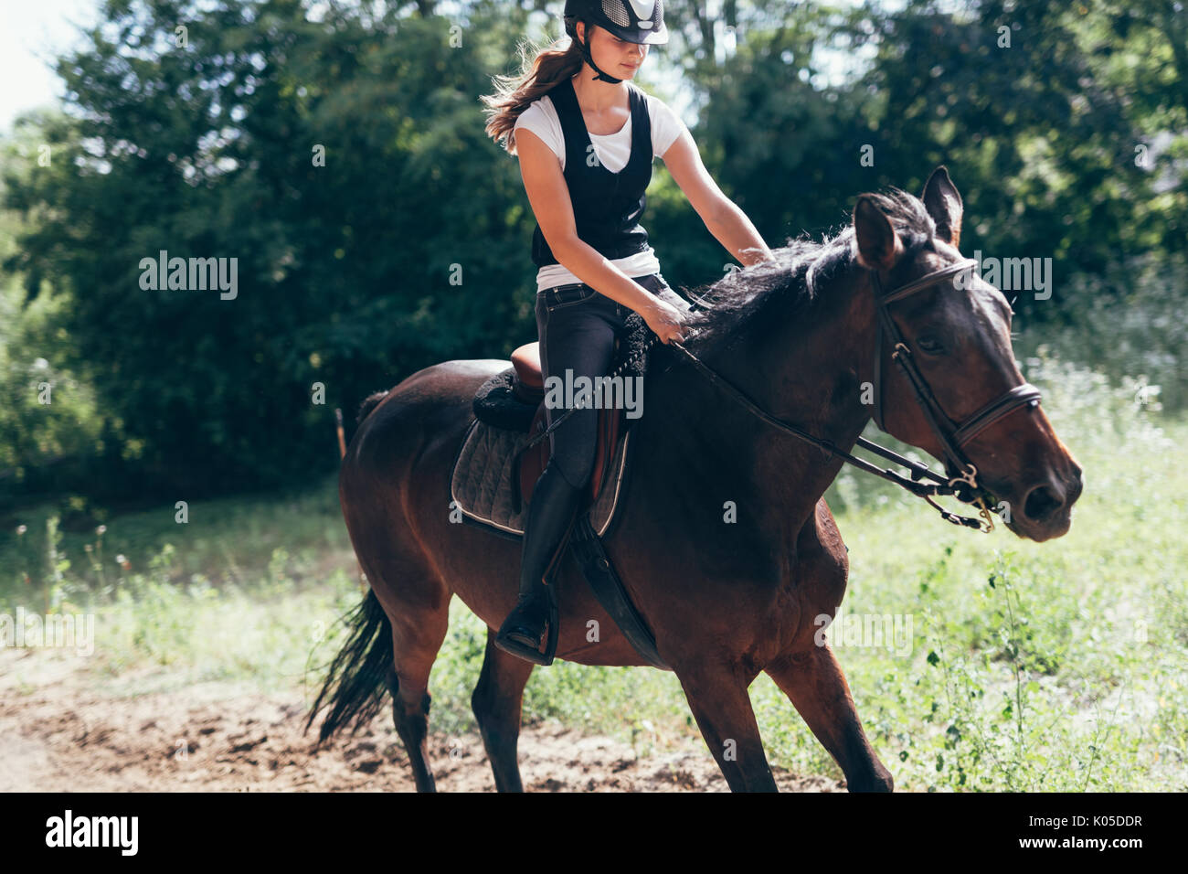 Picture of young girl riding her horse Stock Photo
