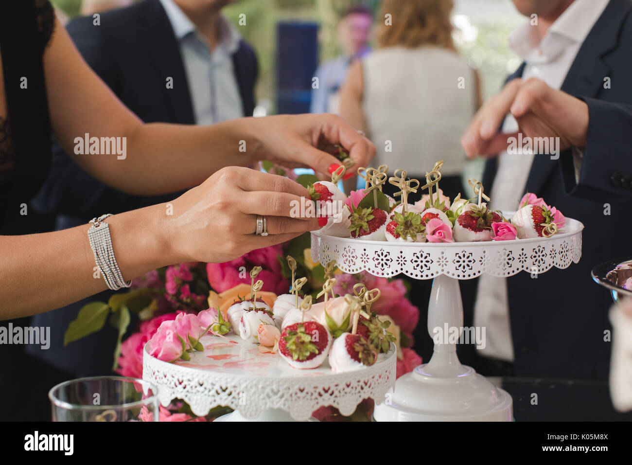 People taking sweet appetizers Stock Photo