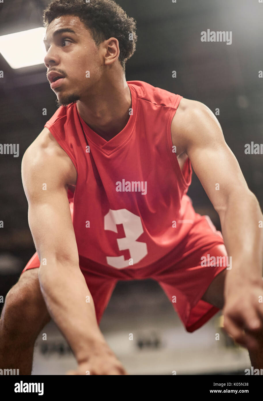 Determined young male basketball player dribbling the ball Stock Photo