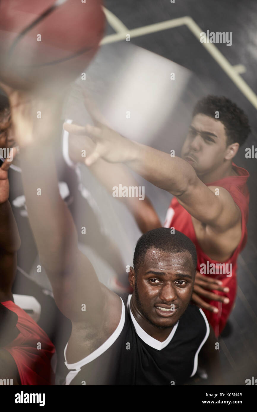 Determined young male basketball player dunking the ball Stock Photo