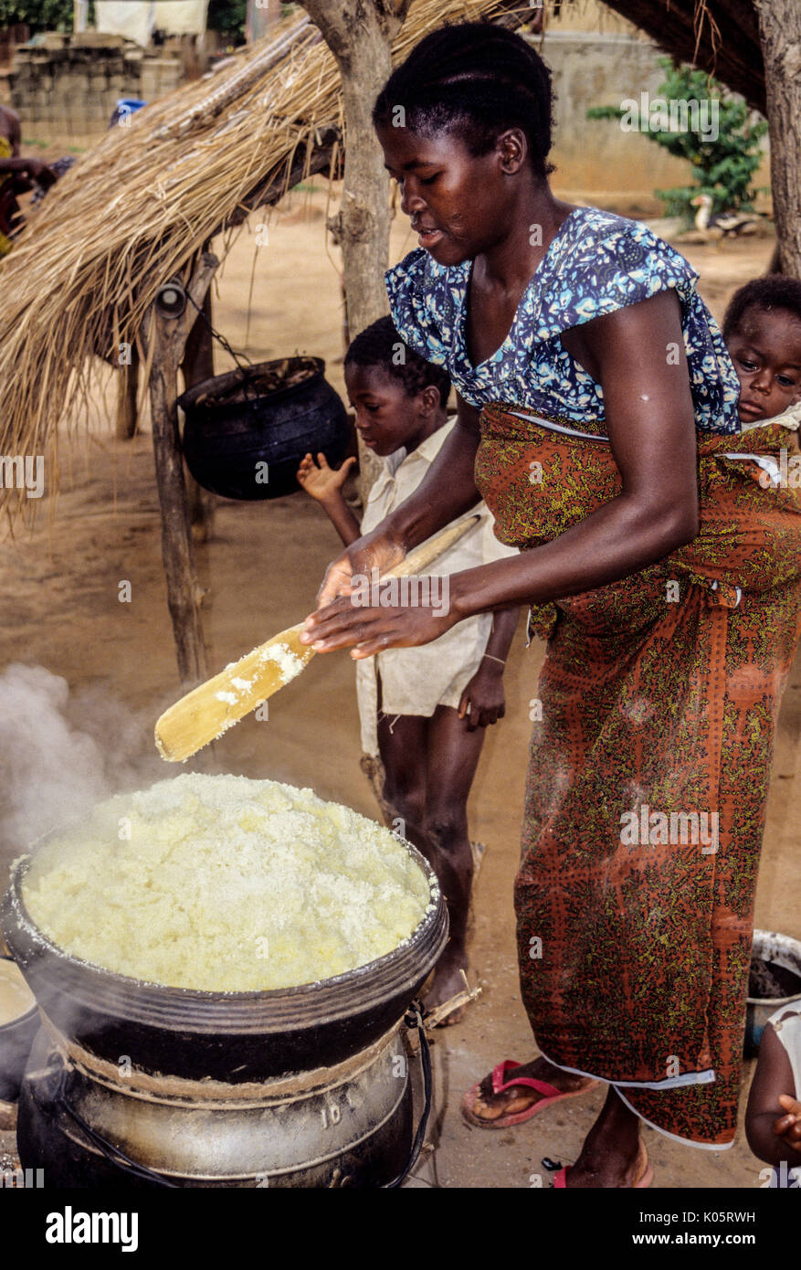 Bamoro, Cote d'Ivoire (Ivory Coast).  Village Woman Preparing Atieke, a Starchy Staple Made from Cassava. Stock Photo