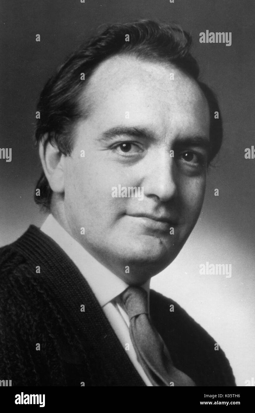 Head-shot portrait of English writer and critic Clive Barnes, shot in front of a backdrop, wearing a white shirt and tie, with a dark cardigan, with a serious facial expression, 1977. Stock Photo