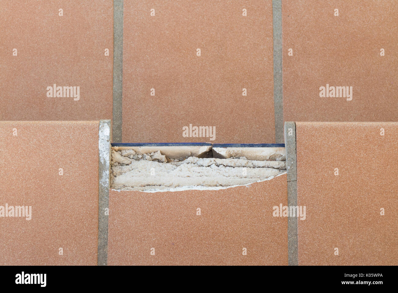 Broken tile on outdoor stairs steps - see also image K05WRD for front on view Stock Photo