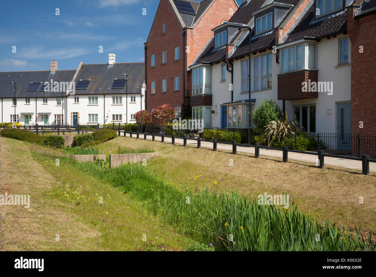 Mixed housing styles to be found within the contemporary suburban development with a sustainable drainage system, Upton in Northampton, England. Stock Photo