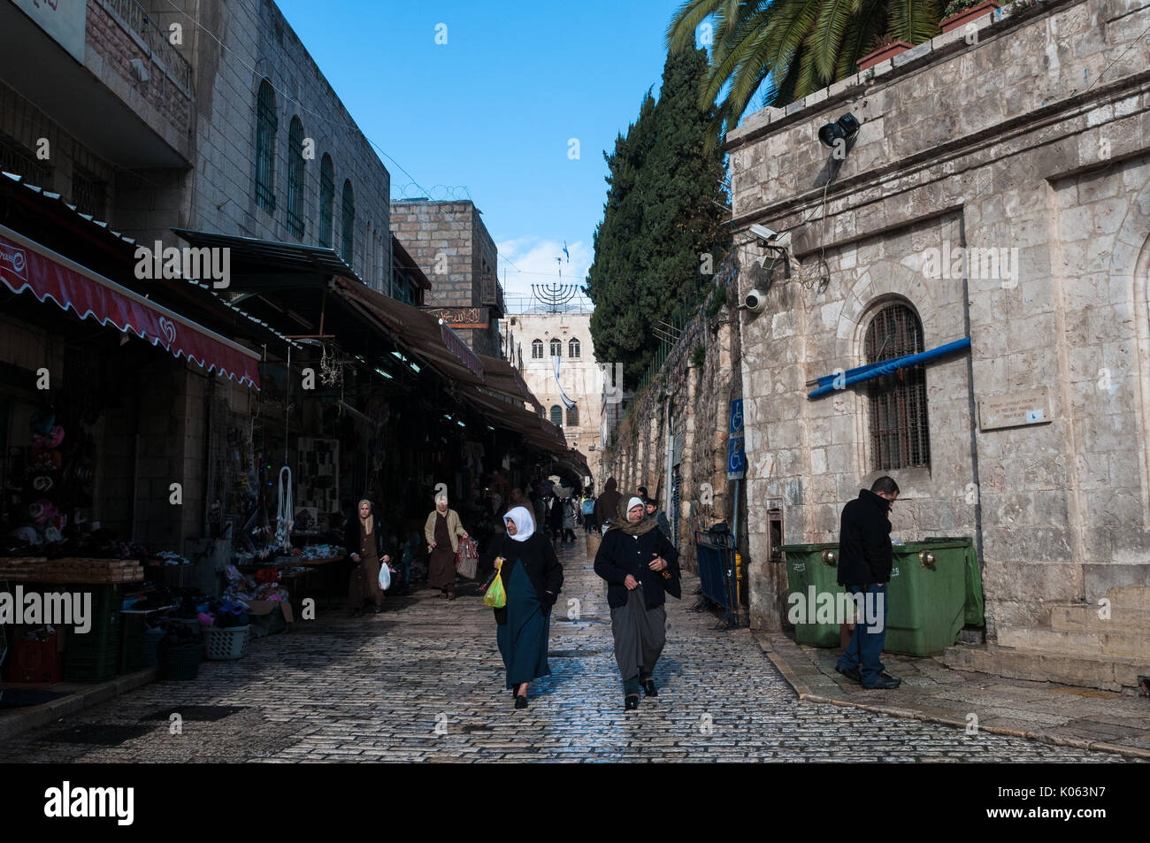 Muslim women walk along El Wad road, Muslim Quarter, Jerusalem. Stock Photo