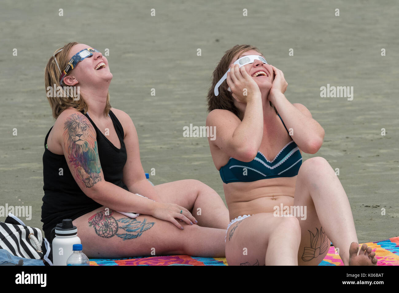 Charleston, Isle of Palms, USA. 21st Aug, 2017. Sunbathers react to the total solar eclipse as it passes over the beach outside Charleston August 21, 2017 in Isle of Palms, South Carolina. The solar eclipse after sweeping across the nation crosses the Charleston area before heading over the Atlantic Ocean. Credit: Planetpix/Alamy Live News Stock Photo