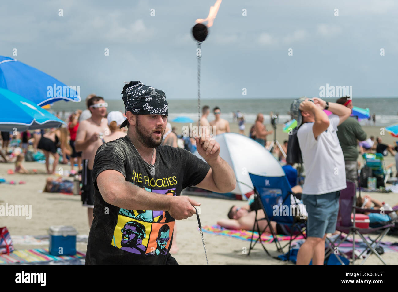 Charleston, Isle of Palms, USA. 21st Aug, 2017. A man twirls fireballs as the total solar eclipse passes over the beach outside Charleston August 21, 2017 in Isle of Palms, South Carolina. The solar eclipse after sweeping across the nation crosses the Charleston area before heading over the Atlantic Ocean. Credit: Planetpix/Alamy Live News Stock Photo