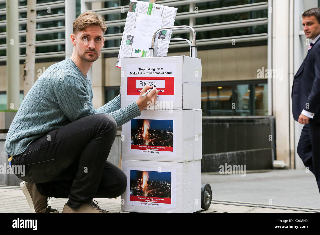 Westminster. London, UK. 22nd Aug, 2017. John Tyson, the founder of a petition to bring in fire safety regulations to make Britain's tower blocks safer poses for media before handing in the petition to the Department for Communities and Local Government (DCLG). The petition of 98,882 signatures to the DCLG follows the critical findings of the 2013 coroner's report on the 2009 Lakanal fire, which highlighted issues that could have prevented Grenfell, the petition is asking for the immediate implementation of recommendations from that report. Credit: Dinendra Haria/Alamy Live News Stock Photo