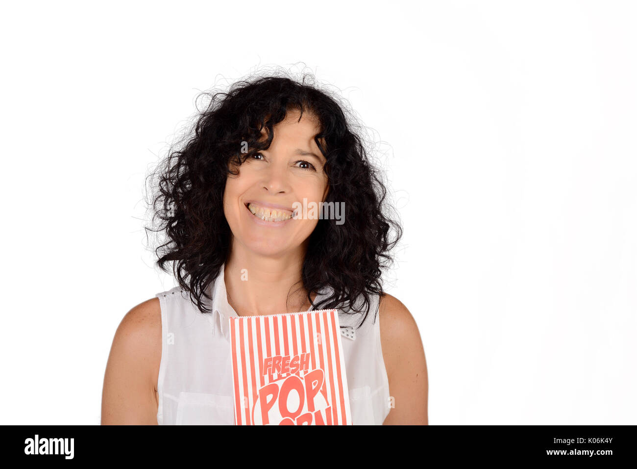 Woman with big thighs holding a larg bag of popcorn Stock Photo