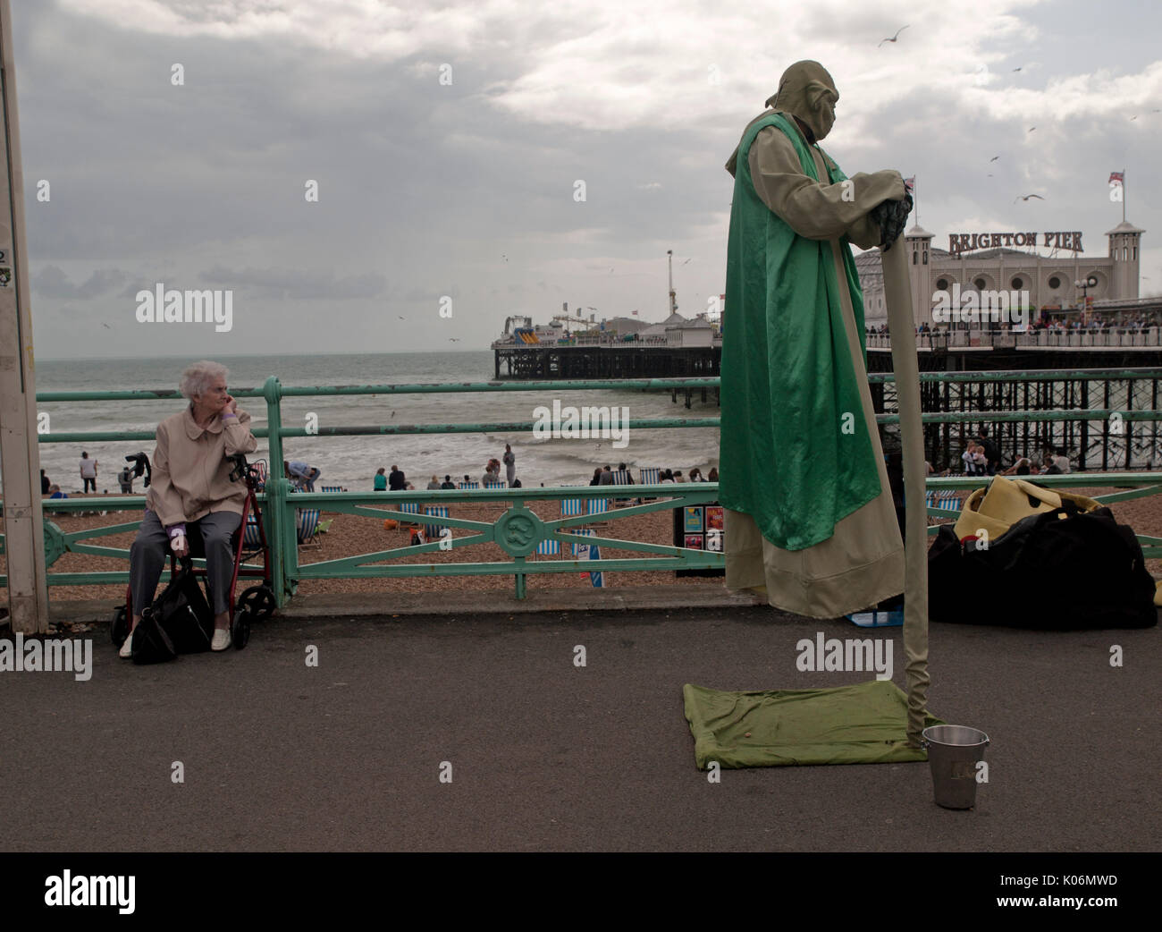On the seafront in Brighton a street entertainer dresses as Yoda from Star Wars Stock Photo