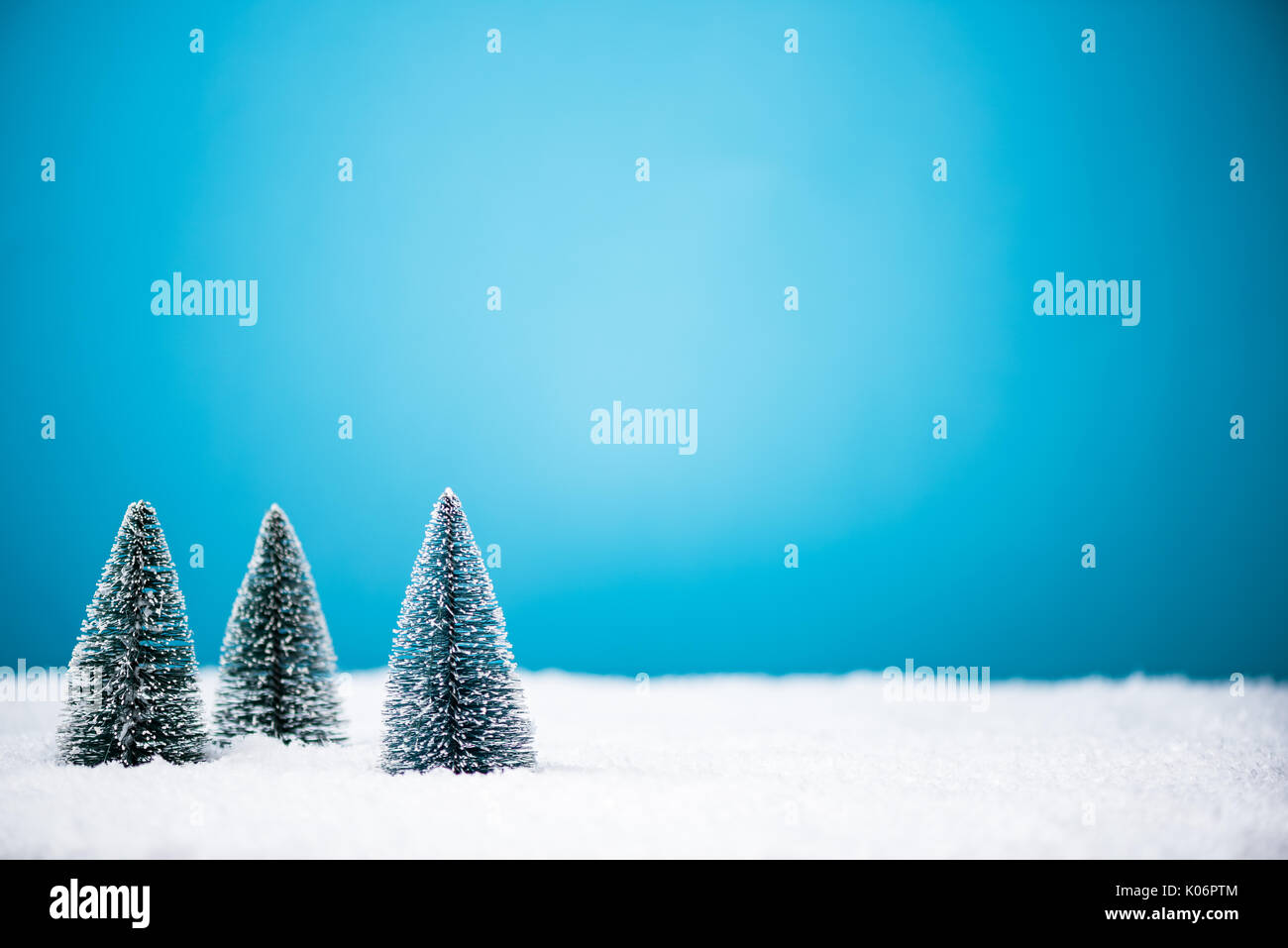 Christmas trees in snow with copy space background Stock Photo - Alamy