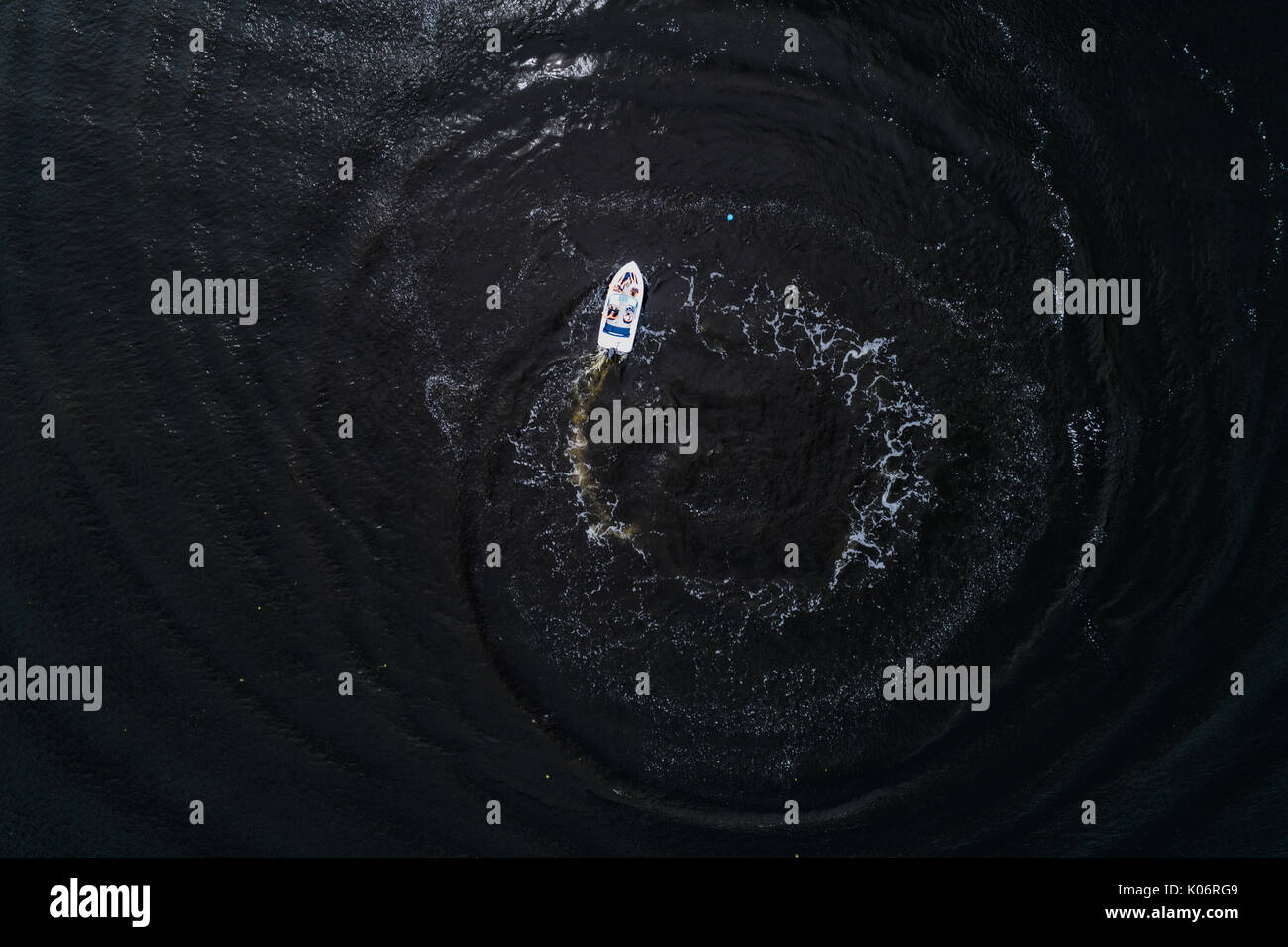 Aerial view of the Dnieper River with a high-speed motor boat that discharges water circles Stock Photo