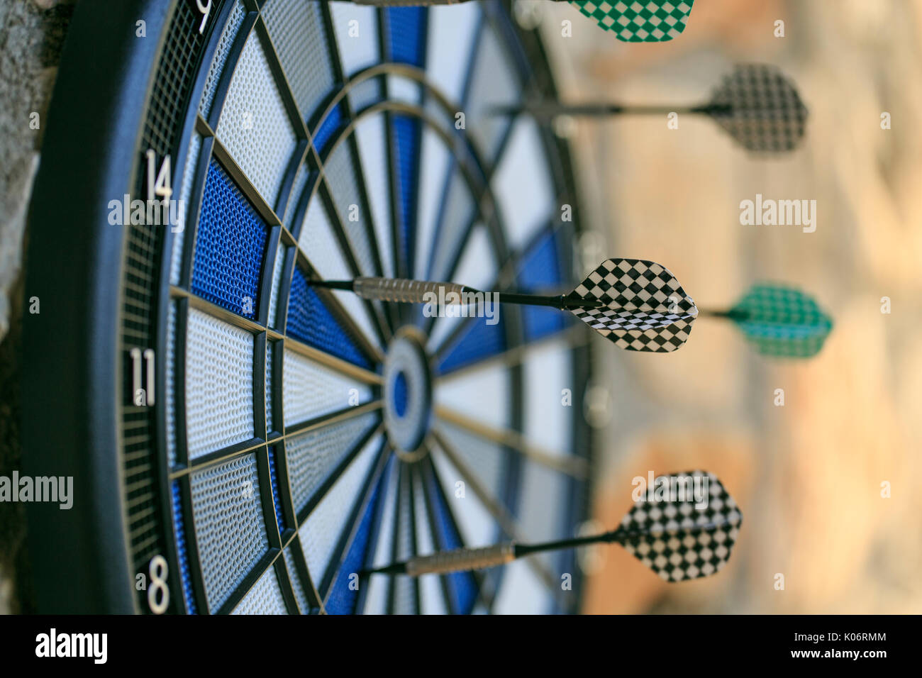 Bullseye on a wall with some darts Stock Photo