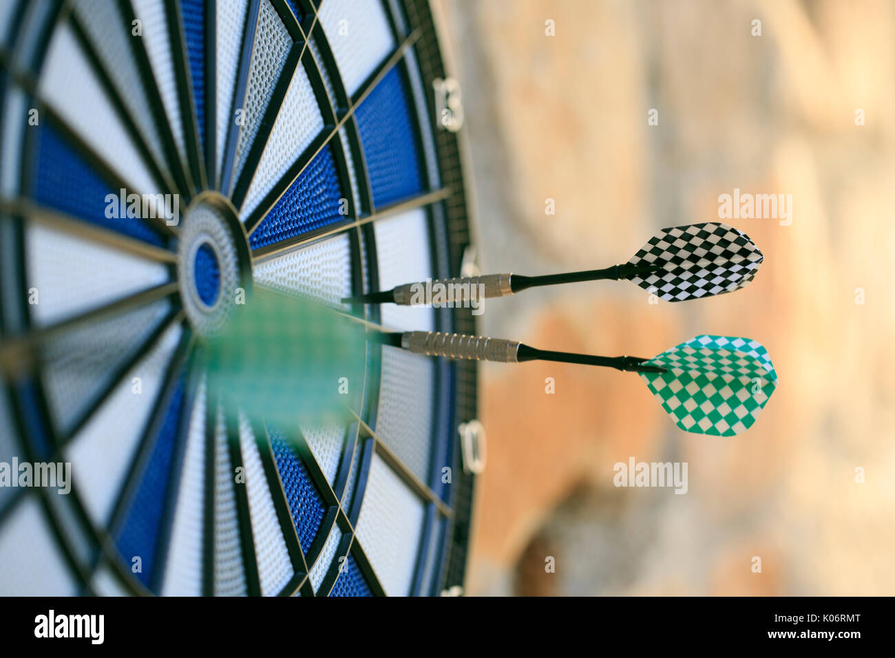 Bullseye on a wall with some darts Stock Photo