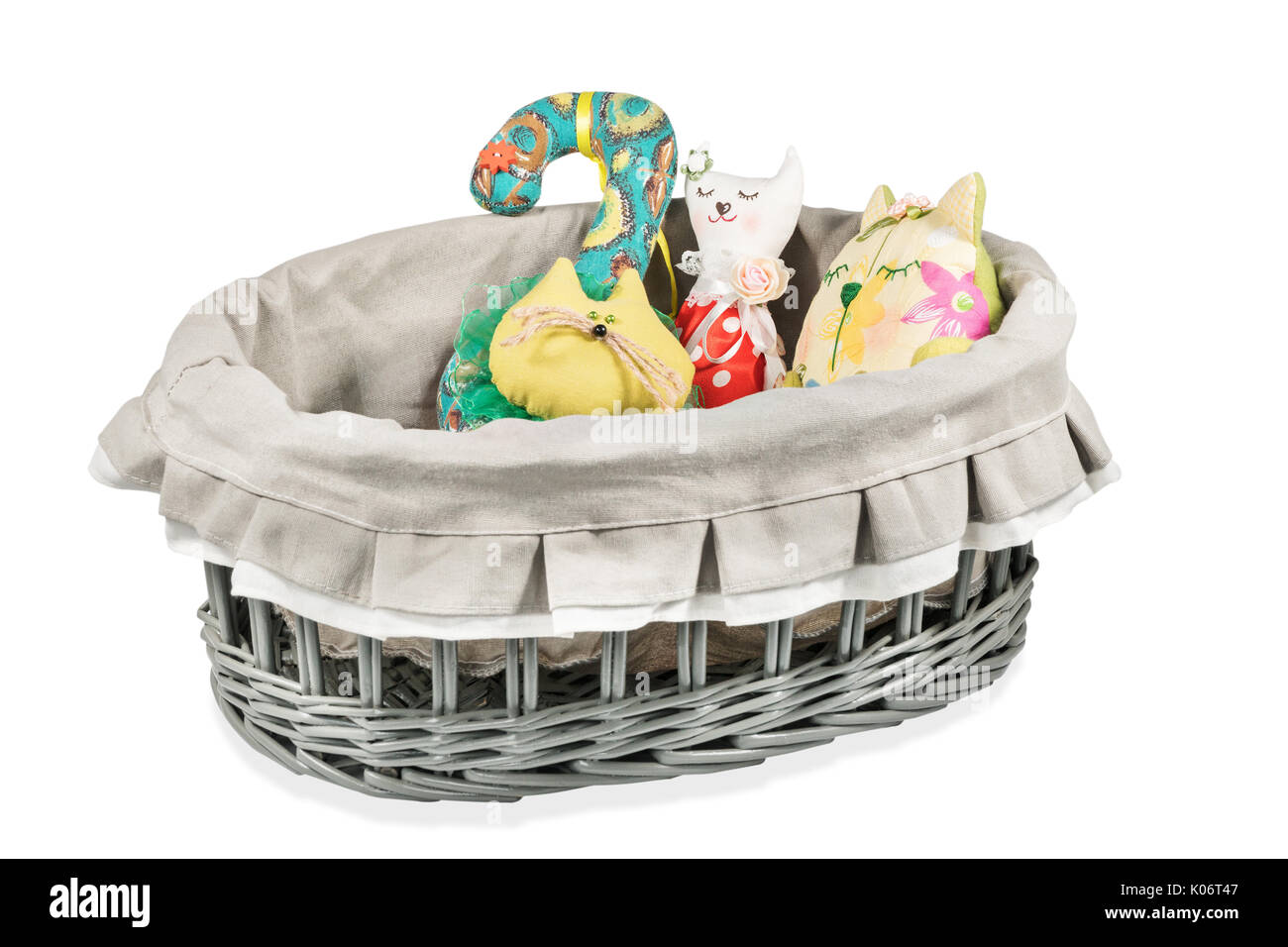 Wicker basket with stuffed cats toys isolated on white background Stock