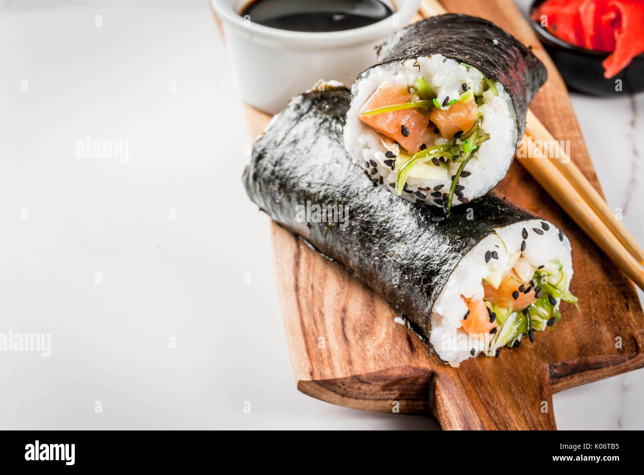 Trend hybrid food. Japanese, Asian cuisine. Sushiburrito, sandwich with salmon, hayashi wakame