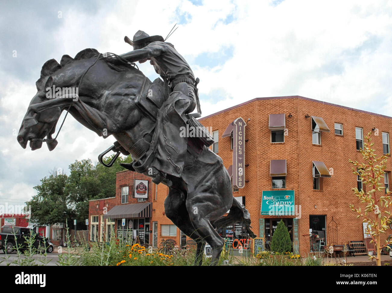 A sculpture called Bronco Buster is in a roundabout on Main Street in Stillwater Oklahoma. Stock Photo