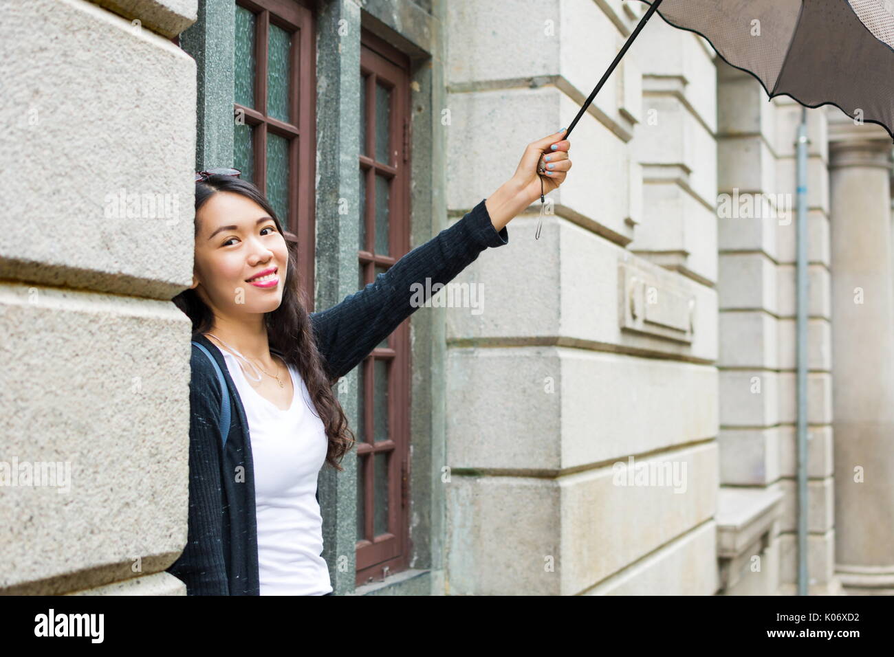 Happy girl holding umbrella hi-res stock photography and images - Alamy