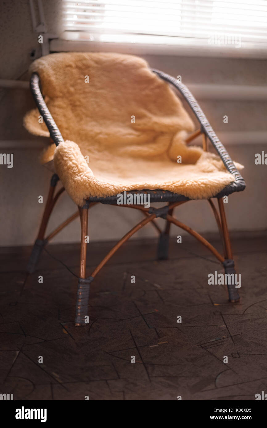 Old wicker chair with sheepskin Stock Photo - Alamy
