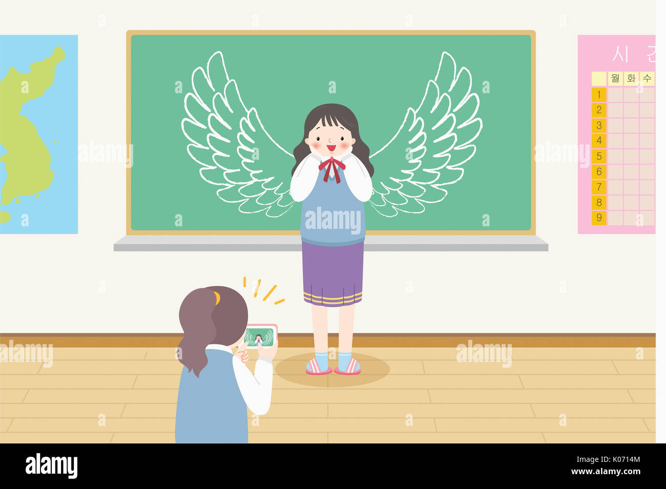 Two smiling school girls posing for selfie in classroom Stock Photo - Alamy