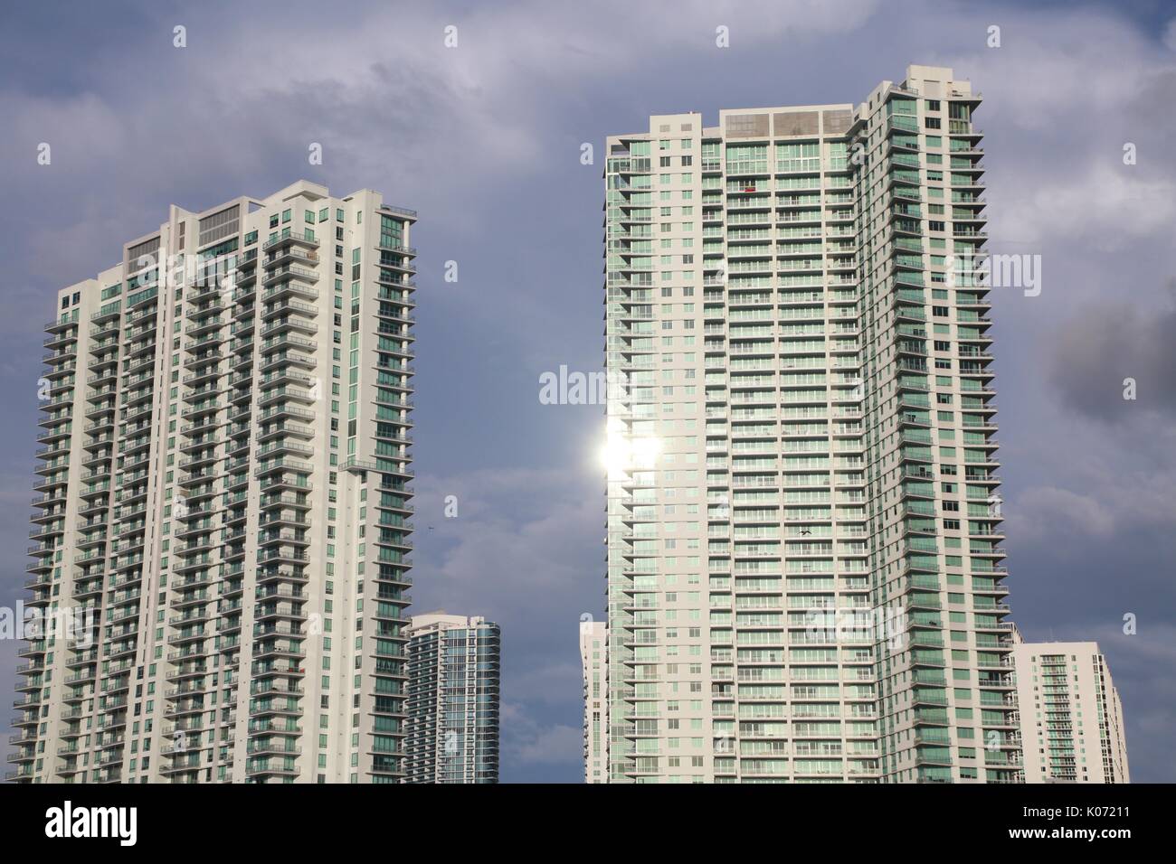Image showcasing Sun Gleaming Off Windows of Luxury High-Rise Condominiums from tthe ...