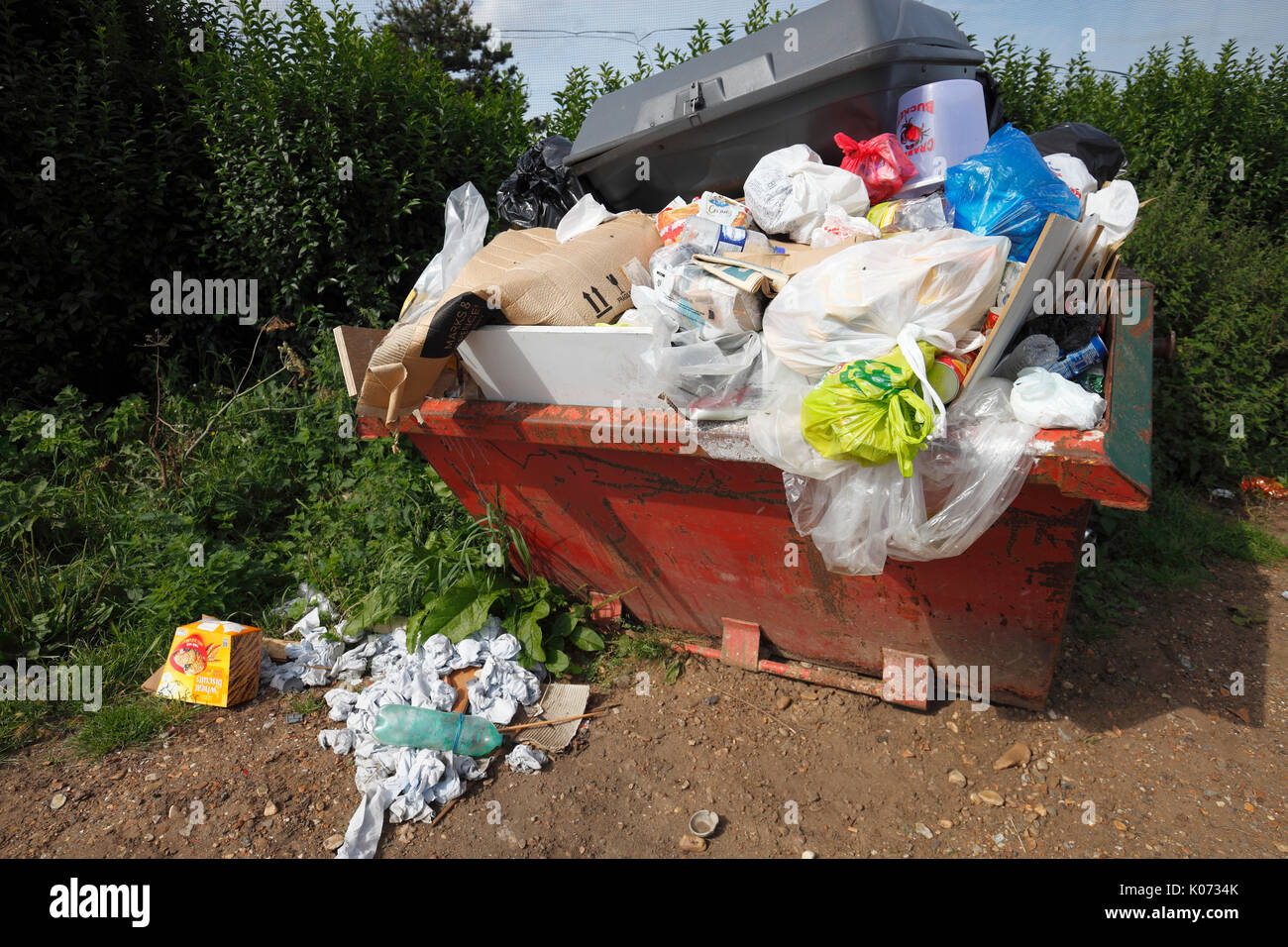Skip overflowing with rubbish. Stock Photo
