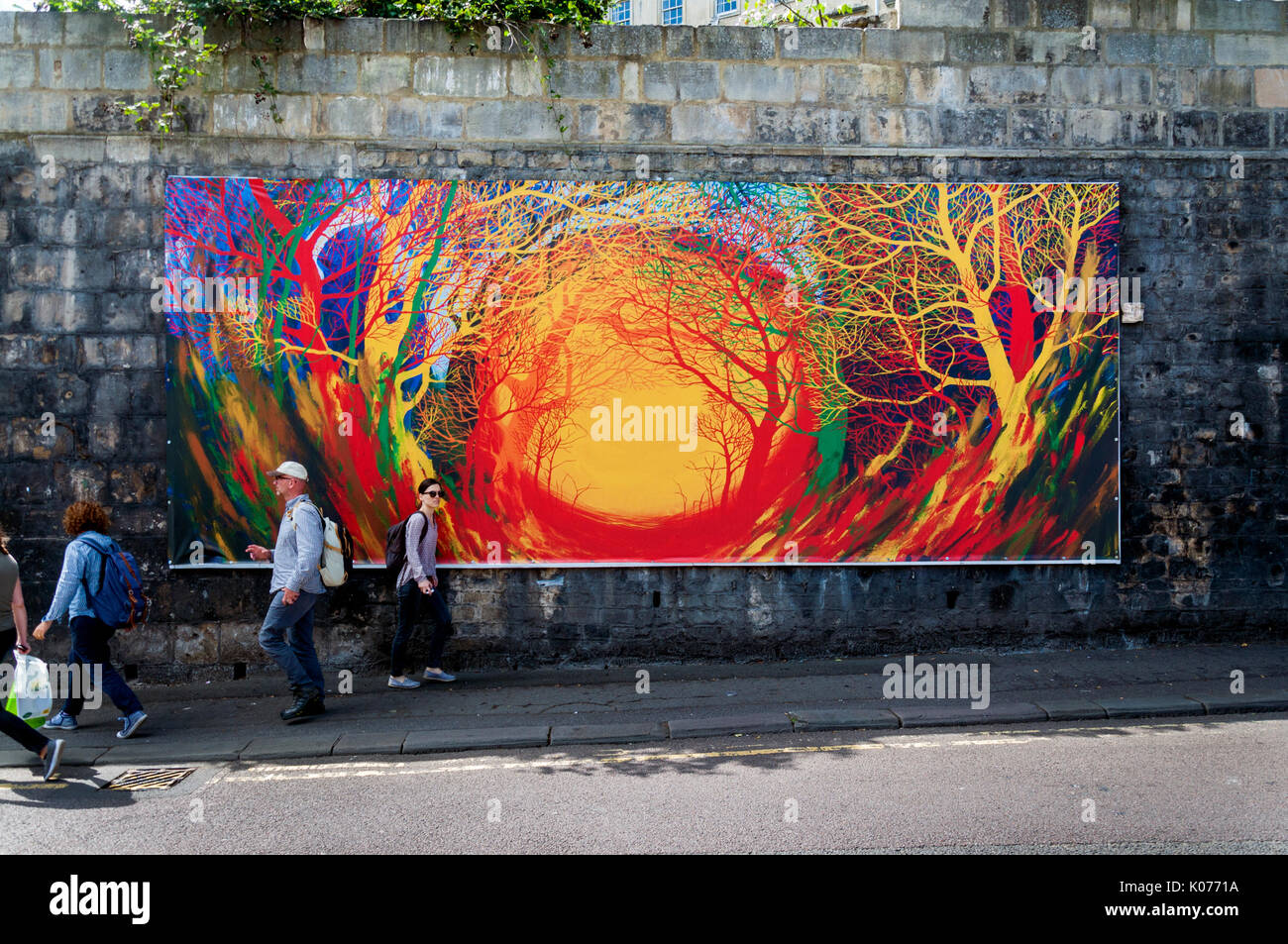 Street art on Walcot Street, Bath,Somerset, UK. People walk past the