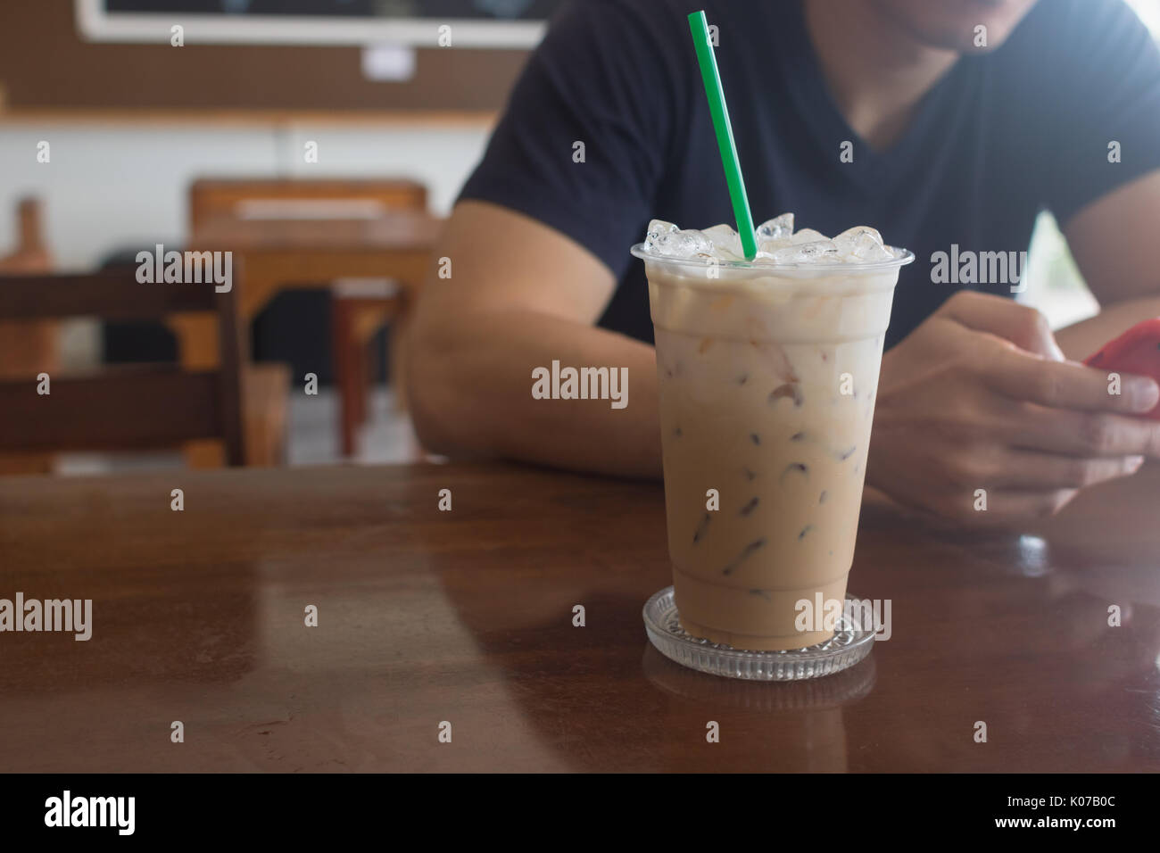 https://c8.alamy.com/comp/K07B0C/iced-coffee-in-take-away-cup-plastic-glass-on-the-wood-table-in-cafe-K07B0C.jpg