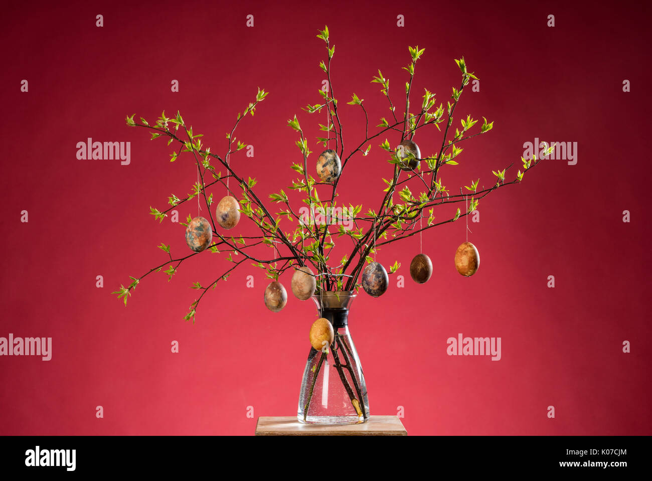 Vase with tree branches and multicolored hand painted easter eggs Stock Photo