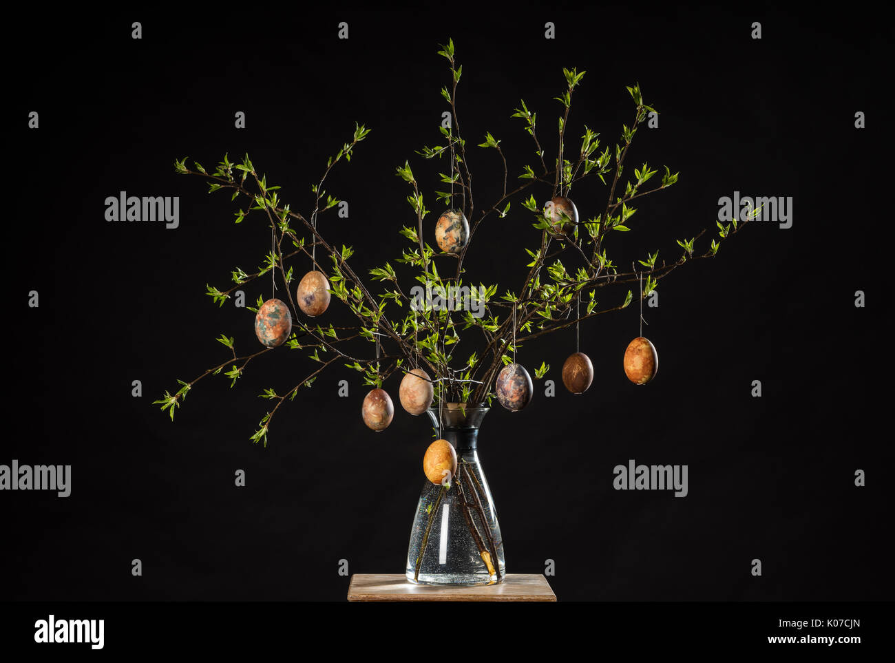 Vase with tree branches and multicolored hand painted easter eggs Stock Photo
